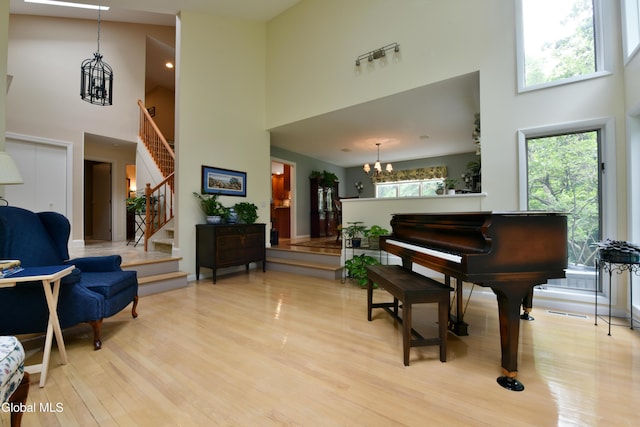14 Friar Tuck Ct, Clifton Park, NY 12065 - sitting room with a high ceiling, a chandelier, stairs, and light wood-type flooring