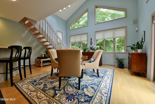 14 Friar Tuck Ct, Clifton Park, NY 12065 - dining space featuring high vaulted ceiling, stairway, and wood finished floors