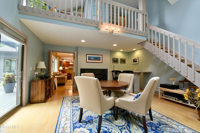 14 Friar Tuck Ct, Clifton Park, NY 12065 - dining room featuring wood finished floors, stairway, a fireplace, a high ceiling, and recessed lighting