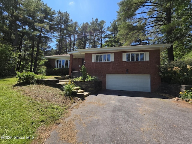 1718 Thacher Park Rd, Berne, NY 12059 - single story home with asphalt driveway, a garage, and brick siding