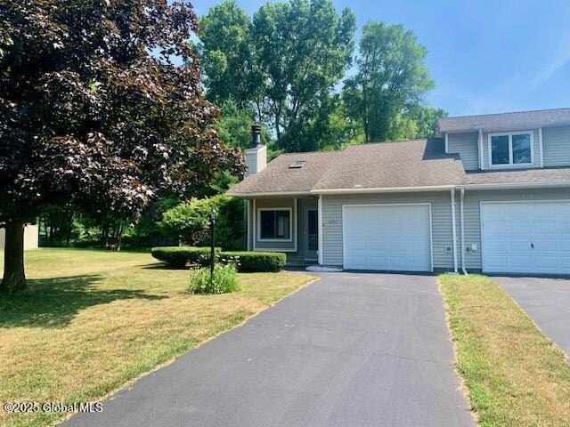 2059 Rosedale Way, Guilderland, NY 12303 - view of front facade with asphalt driveway, an attached garage, a front yard, and a chimney