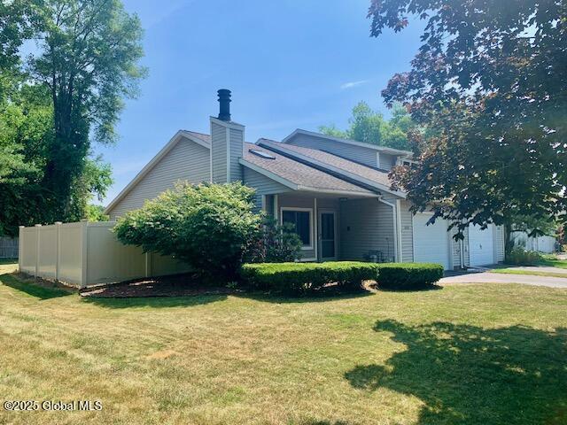 2059 Rosedale Way, Guilderland, NY 12303 - view of property exterior with concrete driveway, a chimney, and an attached garage