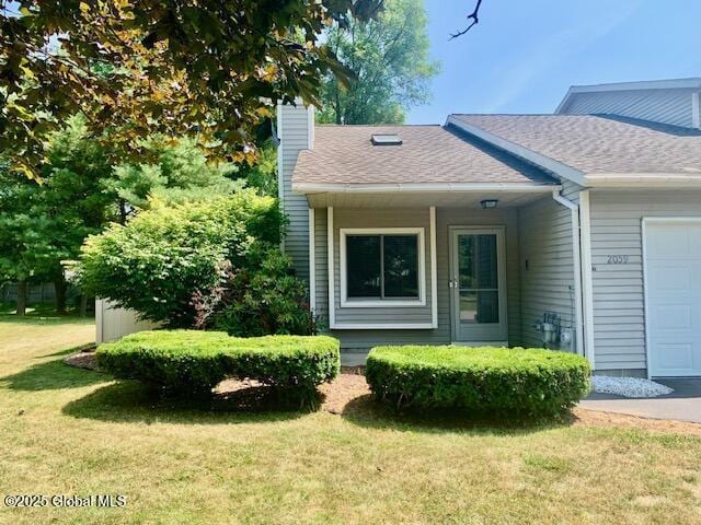 2059 Rosedale Way, Guilderland, NY 12303 - view of home's exterior featuring an attached garage, a chimney, a yard, and roof with shingles