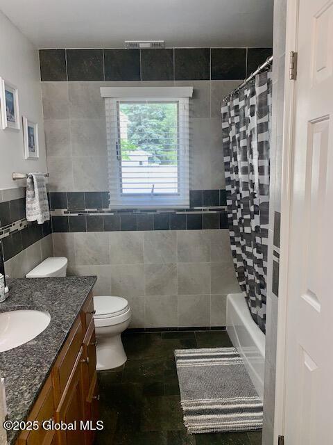 2059 Rosedale Way, Guilderland, NY 12303 - full bath with tile walls, vanity, and shower / bath combo with shower curtain
