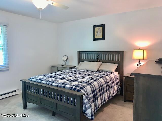 2059 Rosedale Way, Guilderland, NY 12303 - bedroom featuring light carpet, a baseboard heating unit, and ceiling fan