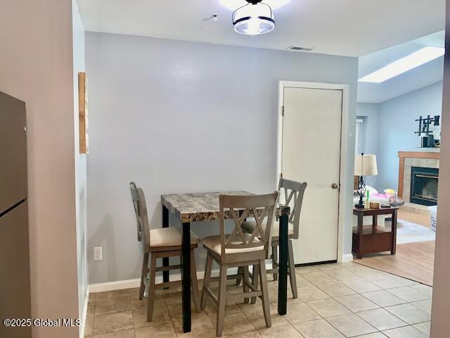 2059 Rosedale Way, Guilderland, NY 12303 - dining area featuring light tile patterned floors and a tiled fireplace
