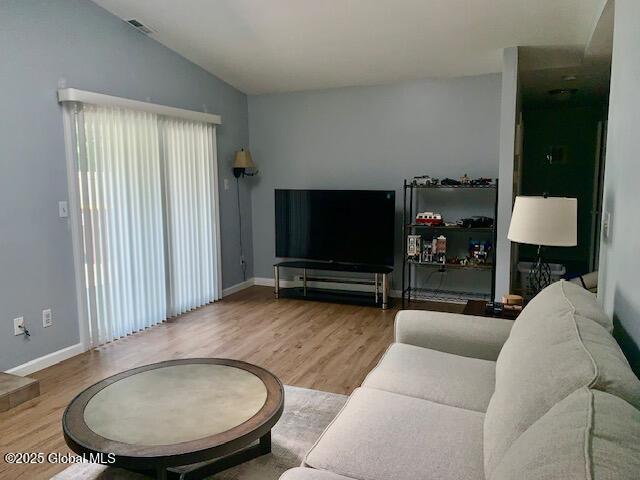 2059 Rosedale Way, Guilderland, NY 12303 - living area featuring wood finished floors and lofted ceiling