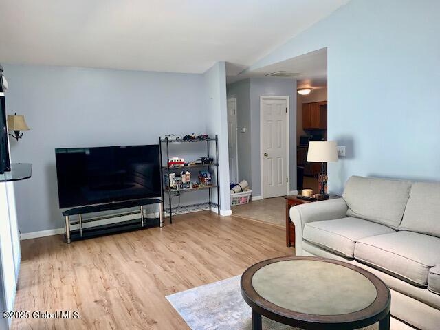 2059 Rosedale Way, Guilderland, NY 12303 - living area with light wood-type flooring and lofted ceiling