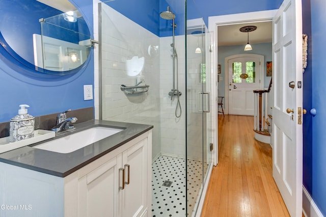 1151 Oxford Pl, Schenectady, NY 12308 - bathroom featuring a stall shower, vanity, and hardwood / wood-style flooring