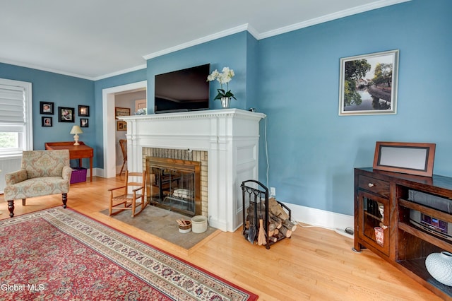 1151 Oxford Pl, Schenectady, NY 12308 - living room with wood finished floors, ornamental molding, and a brick fireplace