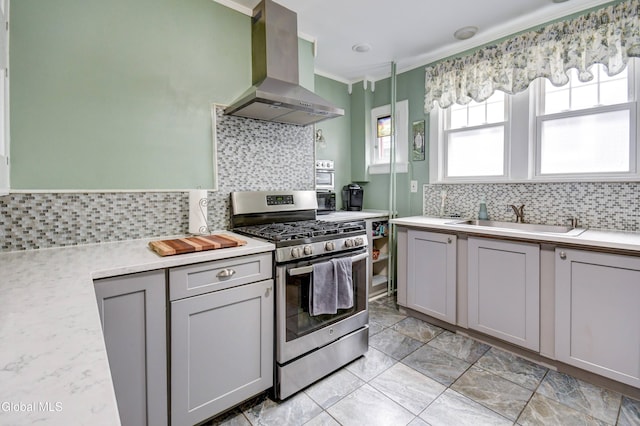 1151 Oxford Pl, Schenectady, NY 12308 - kitchen featuring gas stove, wall chimney range hood, crown molding, tasteful backsplash, and light countertops
