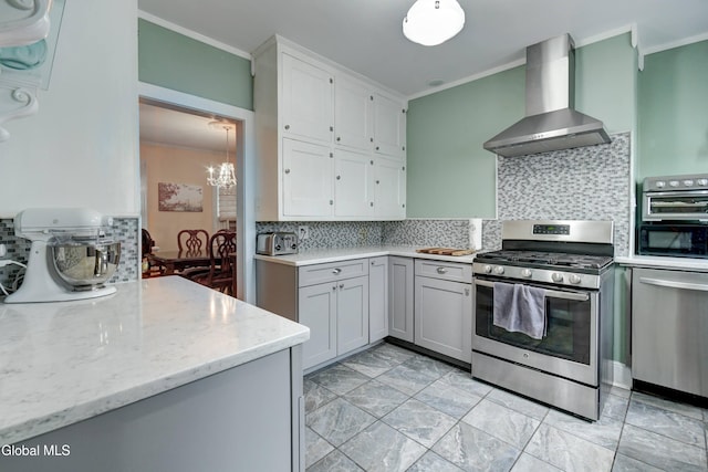 1151 Oxford Pl, Schenectady, NY 12308 - kitchen with wall chimney exhaust hood, appliances with stainless steel finishes, crown molding, tasteful backsplash, and light stone countertops