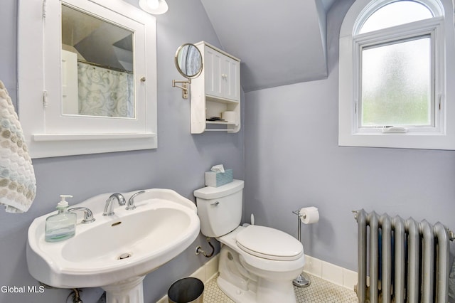 1151 Oxford Pl, Schenectady, NY 12308 - bathroom with radiator heating unit, vaulted ceiling, and tile patterned flooring