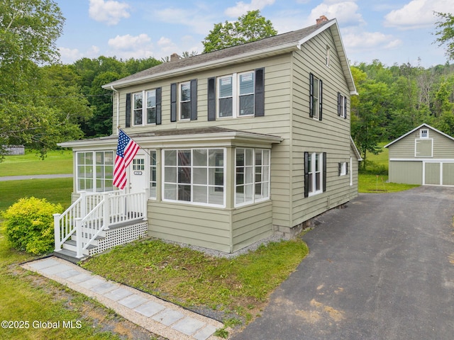 1707 Helderberg Trl, Berne, NY 12023 - view of front of property with a chimney, an outbuilding, a front lawn, and roof with shingles