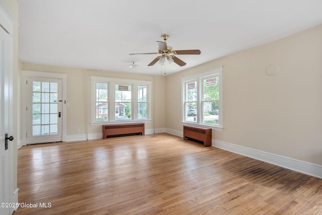1707 Helderberg Trl, Berne, NY 12023 - empty room with radiator heating unit, light wood-style floors, and a ceiling fan