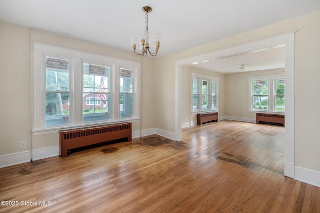 1707 Helderberg Trl, Berne, NY 12023 - spare room with radiator, light wood-style floors, and a chandelier