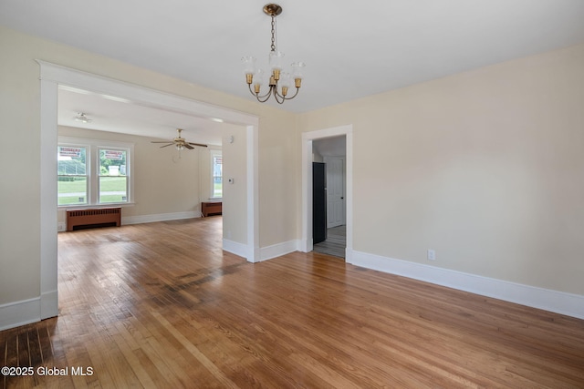 1707 Helderberg Trl, Berne, NY 12023 - spare room featuring radiator heating unit, a chandelier, and light wood-type flooring