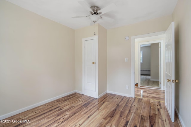1707 Helderberg Trl, Berne, NY 12023 - unfurnished bedroom with wood finished floors, a ceiling fan, and radiator heating unit