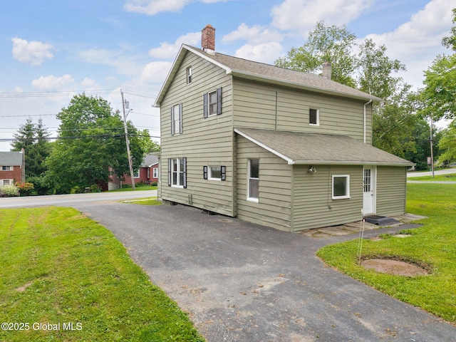 1707 Helderberg Trl, Berne, NY 12023 - view of home's exterior featuring a chimney, a lawn, and a shingled roof