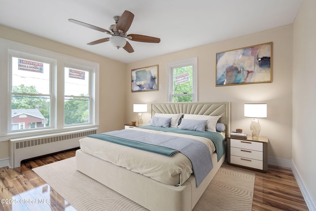 1707 Helderberg Trl, Berne, NY 12023 - bedroom featuring radiator, wood finished floors, and a ceiling fan