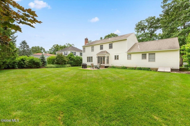630 Salvia Ln, Guilderland, NY 12303 - rear view of property with a lawn, a patio area, and a chimney