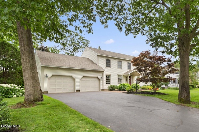 630 Salvia Ln, Guilderland, NY 12303 - colonial inspired home with an attached garage, a front lawn, and asphalt driveway