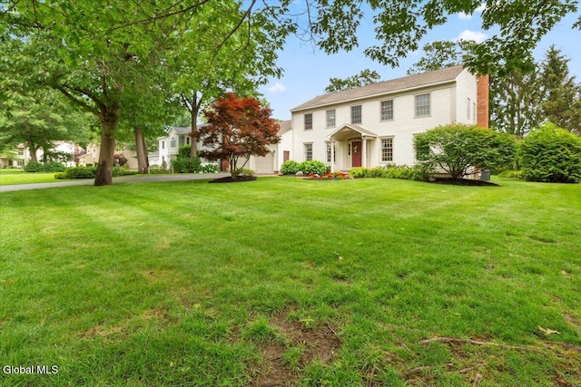 630 Salvia Ln, Guilderland, NY 12303 - colonial-style house featuring a chimney and a front lawn