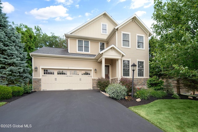 21 Beacon Dr, Colonie, NY 12189 - craftsman-style house featuring asphalt driveway, stone siding, a front lawn, and board and batten siding