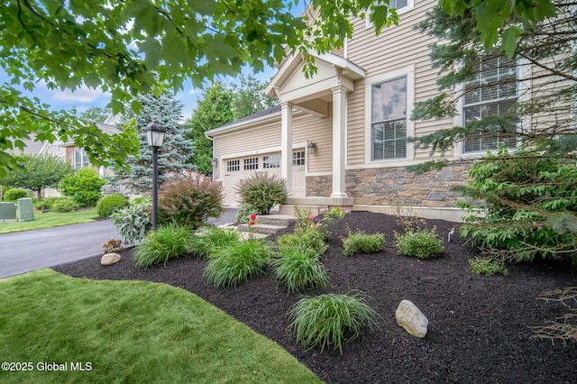 21 Beacon Dr, Colonie, NY 12189 - view of front of property featuring stone siding and a garage