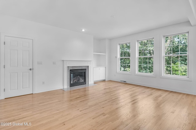 21 Beacon Dr, Colonie, NY 12189 - unfurnished living room with light wood finished floors, a fireplace, built in shelves, and recessed lighting