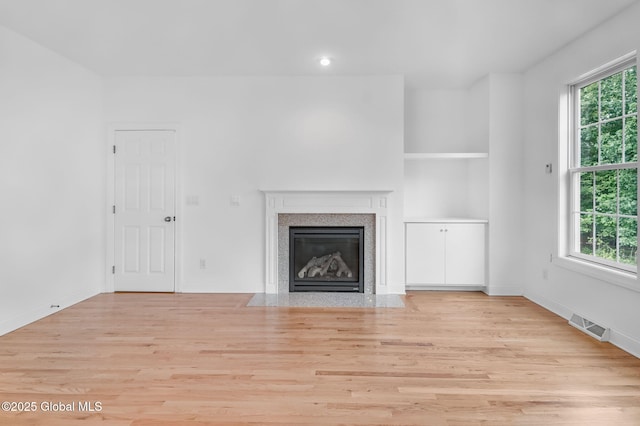 21 Beacon Dr, Colonie, NY 12189 - unfurnished living room featuring light wood-type flooring, a premium fireplace, and recessed lighting