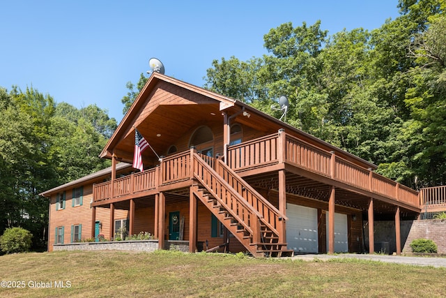345 Goodman Rd, Fort Ann, NY 12827 - back of property featuring a wooden deck, a yard, stairway, and a garage