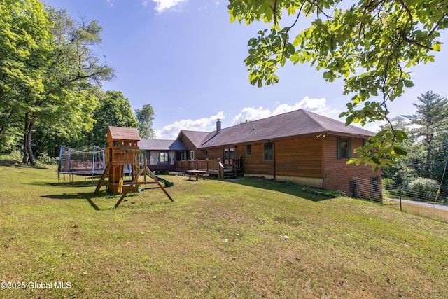 345 Goodman Rd, Fort Ann, NY 12827 - view of grassy yard featuring a trampoline, a wooden deck, and a playground