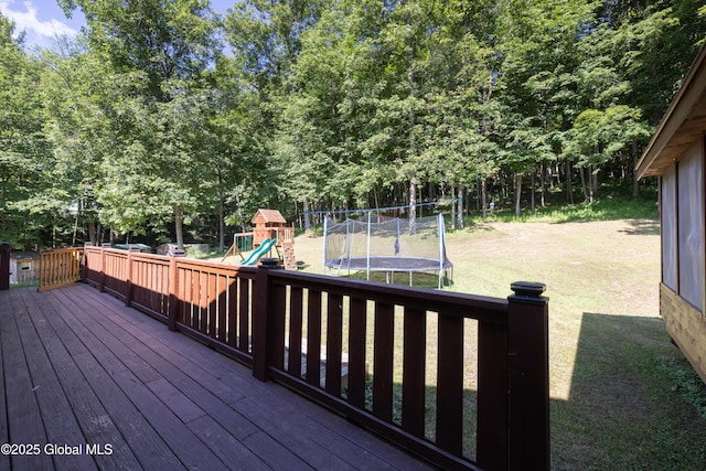 345 Goodman Rd, Fort Ann, NY 12827 - wooden terrace featuring a trampoline, a playground, and a yard