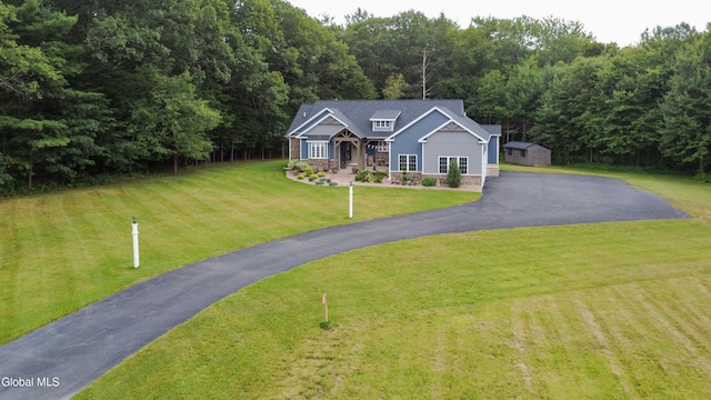 2794 W Lydius St, Schenectady, NY 12306 - view of front of house with a storage shed, a front lawn, covered porch, stone siding, and driveway