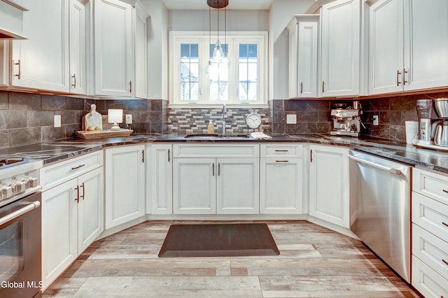 2794 W Lydius St, Schenectady, NY 12306 - kitchen featuring stainless steel appliances, light wood-style flooring, pendant lighting, and a chandelier
