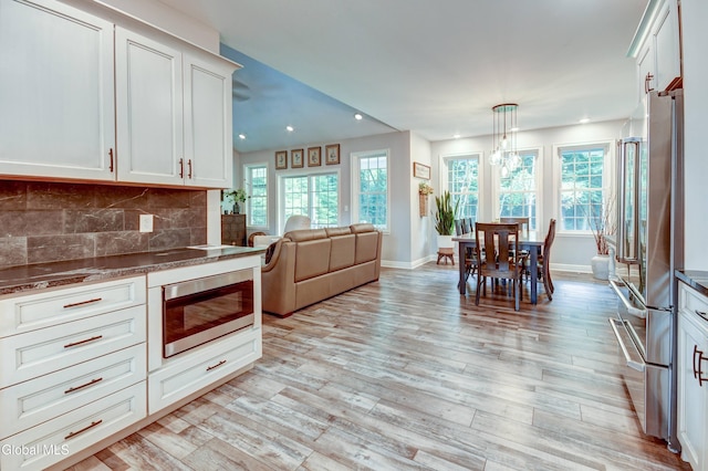 2794 W Lydius St, Schenectady, NY 12306 - kitchen with stainless steel appliances, recessed lighting, light wood-style floors, open floor plan, and tasteful backsplash
