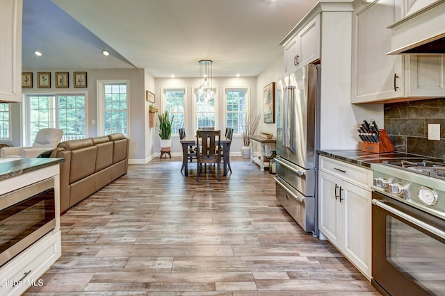 2794 W Lydius St, Schenectady, NY 12306 - kitchen featuring appliances with stainless steel finishes, dark countertops, recessed lighting, custom range hood, and light wood finished floors