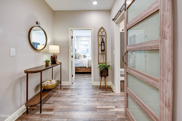 2794 W Lydius St, Schenectady, NY 12306 - hallway with wood finished floors, a barn door, and recessed lighting