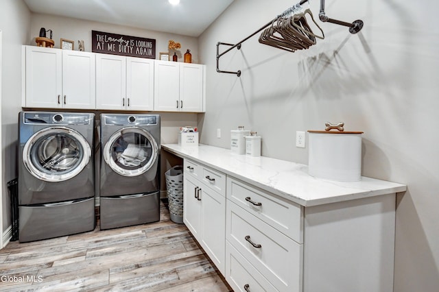 2794 W Lydius St, Schenectady, NY 12306 - washroom with cabinet space, separate washer and dryer, and light wood finished floors