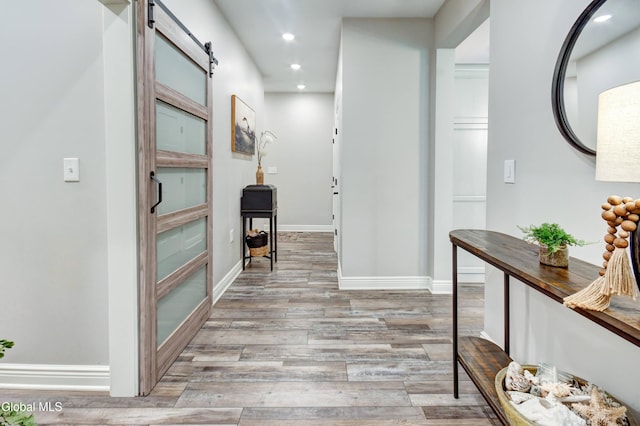 2794 W Lydius St, Schenectady, NY 12306 - hallway featuring a barn door, recessed lighting, and wood finished floors