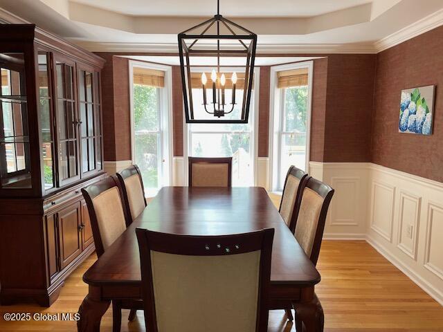 6 Patroon Way, Halfmoon, NY 12065 - dining area with a chandelier, a wainscoted wall, light wood finished floors, a raised ceiling, and wallpapered walls