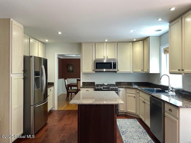 6 Patroon Way, Halfmoon, NY 12065 - kitchen featuring stainless steel appliances, recessed lighting, dark stone counters, dark wood finished floors, and a center island