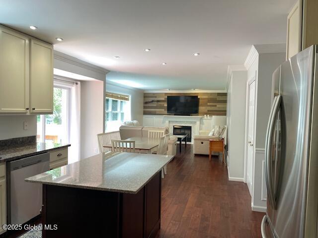 6 Patroon Way, Halfmoon, NY 12065 - kitchen with appliances with stainless steel finishes, a fireplace, dark stone countertops, dark wood-style flooring, and recessed lighting