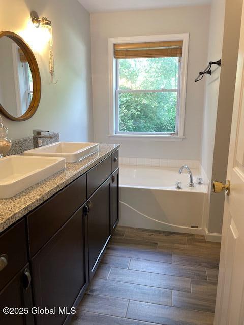 6 Patroon Way, Halfmoon, NY 12065 - bathroom featuring double vanity, a bath, and wood finished floors