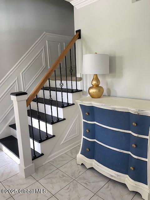 6 Patroon Way, Halfmoon, NY 12065 - staircase with marble look tiles, a decorative wall, and ornamental molding