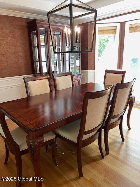 6 Patroon Way, Halfmoon, NY 12065 - dining space featuring a chandelier, wainscoting, light wood-type flooring, and a decorative wall