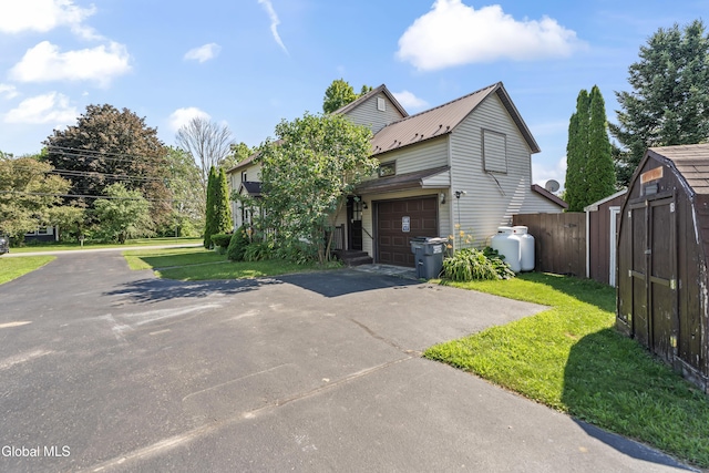 2289 Hickory Hill Rd, Mohawk, NY 12068 - view of front of house with driveway, an attached garage, a shed, and a metal roof