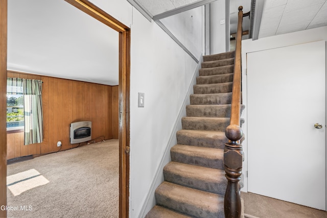 2289 Hickory Hill Rd, Mohawk, NY 12068 - stairway featuring heating unit, carpet, wood walls, a wood stove, and a baseboard heating unit