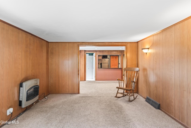 2289 Hickory Hill Rd, Mohawk, NY 12068 - unfurnished room featuring heating unit, carpet flooring, wood walls, and a wood stove
